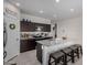 Modern kitchen with stainless steel appliances, granite countertops, and dark cabinets at 5146 E Diatomite Dr, San Tan Valley, AZ 85143
