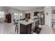 Kitchen island featuring a stainless steel dishwasher and sink with a view into the dining area at 5146 E Diatomite Dr, San Tan Valley, AZ 85143