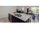 Kitchen island with a double sink, granite countertops, and a view into the living area at 5146 E Diatomite Dr, San Tan Valley, AZ 85143