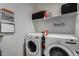 This laundry room features modern LG washer and dryer, storage shelves, and laundry-themed decor, maximizing space and efficiency at 5146 E Diatomite Dr, San Tan Valley, AZ 85143
