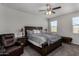 Comfortable main bedroom with a ceiling fan, large bed, and natural light at 5146 E Diatomite Dr, San Tan Valley, AZ 85143