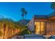 Stunning backyard showcasing lush landscaping, palm trees, and cozy outdoor seating at twilight at 5434 E Lincoln Dr # 58, Paradise Valley, AZ 85253