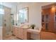 Luxurious bathroom with a glass shower, stylish vanity, and custom closet space at 5434 E Lincoln Dr # 58, Paradise Valley, AZ 85253