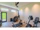Well-equipped home gym with various exercise machines and natural light at 5434 E Lincoln Dr # 58, Paradise Valley, AZ 85253