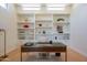 Sophisticated home office featuring built-in bookshelves and a modern desk at 5434 E Lincoln Dr # 58, Paradise Valley, AZ 85253
