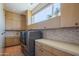 Well-organized laundry room featuring modern appliances, custom cabinetry, and a bright window at 5434 E Lincoln Dr # 58, Paradise Valley, AZ 85253