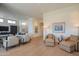 Bright living room showcasing an open layout, neutral furnishings, and hardwood flooring throughout at 5434 E Lincoln Dr # 58, Paradise Valley, AZ 85253