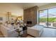 Open-concept living room featuring a modern fireplace, sleek furniture, and seamless indoor-outdoor flow at 5434 E Lincoln Dr # 58, Paradise Valley, AZ 85253