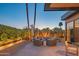 Inviting outdoor lounge area with comfortable seating, lush greenery, and a tranquil water feature at 5434 E Lincoln Dr # 58, Paradise Valley, AZ 85253