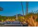 Inviting outdoor patio with mountain views, featuring stylish seating and lush landscaping at twilight at 5434 E Lincoln Dr # 58, Paradise Valley, AZ 85253