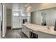 Bathroom featuring white cabinets, double sink, glass shower, and shelving unit at 5549 S Dillon --, Mesa, AZ 85212