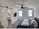 Bright bedroom featuring barn door, ceiling fan, and carpet flooring at 5549 S Dillon --, Mesa, AZ 85212