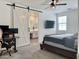 Bright bedroom featuring barn door, desk, and carpet flooring at 5549 S Dillon --, Mesa, AZ 85212