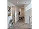 Bright entryway featuring tiled floors, bench with storage, and decorative plants on floating shelves at 5549 S Dillon --, Mesa, AZ 85212