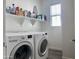 Laundry room with washer, dryer, storage shelving, and natural light at 5549 S Dillon --, Mesa, AZ 85212