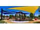 Neighborhood playground with a climbing structure and swings under the colorful canopies at 5549 S Dillon --, Mesa, AZ 85212