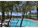 Relaxing community pool surrounded by lush greenery, palm trees and lounge chairs under the bright sky at 5549 S Dillon --, Mesa, AZ 85212