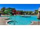 Community pool with slides, fountain, and ample lounge seating under a clear blue sky at 5549 S Dillon --, Mesa, AZ 85212