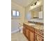 Well-lit bathroom featuring granite counters, framed mirror and tiled floor at 5640 E Bell Rd # 1098, Scottsdale, AZ 85254