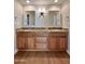 Bathroom featuring dual sinks with granite countertops and custom cabinetry at 5640 E Bell Rd # 1098, Scottsdale, AZ 85254
