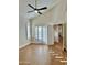 Bright bedroom features a ceiling fan, shutters, and doorway leading to hallway at 5640 E Bell Rd # 1098, Scottsdale, AZ 85254