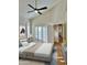 Bright bedroom features a ceiling fan, shutters, and doorway leading to hallway at 5640 E Bell Rd # 1098, Scottsdale, AZ 85254