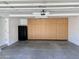 Spacious garage with built in cabinets, additional refrigerator, and clean, concrete floors at 5640 E Bell Rd # 1098, Scottsdale, AZ 85254