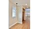 Hallway with wood-look flooring, overhead lighting, and dining nook with bright window at 5640 E Bell Rd # 1098, Scottsdale, AZ 85254