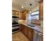 Well-lit kitchen featuring stainless steel appliances, granite countertops, and wood-look floors at 5640 E Bell Rd # 1098, Scottsdale, AZ 85254