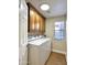 Functional laundry room featuring modern washer and dryer, storage cabinets, and natural light at 5640 E Bell Rd # 1098, Scottsdale, AZ 85254