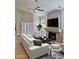 Elegant living room offering stylish decor, natural light, wood floors, a ceiling fan, and a stone fireplace at 5640 E Bell Rd # 1098, Scottsdale, AZ 85254