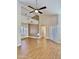 Spacious living room with dining area features wood floors, arched windows, and vaulted ceilings at 5640 E Bell Rd # 1098, Scottsdale, AZ 85254