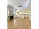 Bright living room features wood floors, arched windows, a ceiling fan, and a cozy fireplace at 5640 E Bell Rd # 1098, Scottsdale, AZ 85254