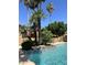 Beautiful community pool surrounded by lush landscaping and mature trees at 5640 E Bell Rd # 1098, Scottsdale, AZ 85254