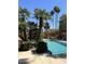 Beautiful community pool surrounded by lush landscaping and mature trees at 5640 E Bell Rd # 1098, Scottsdale, AZ 85254