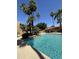 Inviting community pool area with clear water, lush greenery, and pergola at 5640 E Bell Rd # 1098, Scottsdale, AZ 85254