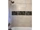 Bathroom shower displaying decorative tile accents and stainless steel shower head and faucet at 5640 E Bell Rd # 1098, Scottsdale, AZ 85254