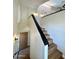 Clean staircase features wood stairs, black railing, and modern lighting with arched windows for natural light at 5640 E Bell Rd # 1098, Scottsdale, AZ 85254