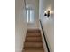Staircase with wood steps, metal handrail, and stylish light fixture at 5640 E Bell Rd # 1098, Scottsdale, AZ 85254