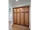 Hallway with ample storage with tall cabinets and wood-look flooring at 5640 E Bell Rd # 1098, Scottsdale, AZ 85254