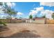 Exterior view of the house shows a large dirt backyard and a block wall fence at 6231 S 2Nd Ave, Phoenix, AZ 85041