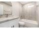 Bathroom features a tiled shower-tub, a granite-look vanity, and modern fixtures at 6231 S 2Nd Ave, Phoenix, AZ 85041
