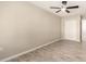Spacious bedroom with wood-look tiled flooring and a ceiling fan at 6231 S 2Nd Ave, Phoenix, AZ 85041