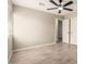 Large, open bedroom featuring wood-look tiled floors and a ceiling fan at 6231 S 2Nd Ave, Phoenix, AZ 85041