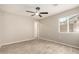 Serene bedroom with neutral walls, ceiling fan, and a bright window at 6231 S 2Nd Ave, Phoenix, AZ 85041