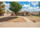 Charming single-story home with a well-manicured front yard and walkway at 6231 S 2Nd Ave, Phoenix, AZ 85041