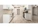 Updated kitchen with white cabinets, granite countertops, stainless appliances, and modern flooring at 6231 S 2Nd Ave, Phoenix, AZ 85041