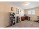 This bedroom features neutral paint, carpeted floors, and a work space by the window at 6244 W Clouse Dr, Phoenix, AZ 85033