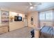 Spacious bedroom featuring neutral tones, carpeted floors, built-in shelving, and a ceiling fan at 6244 W Clouse Dr, Phoenix, AZ 85033
