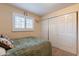 A cozy bedroom with a decorative butterfly and ample storage space with sliding closet doors at 6244 W Clouse Dr, Phoenix, AZ 85033